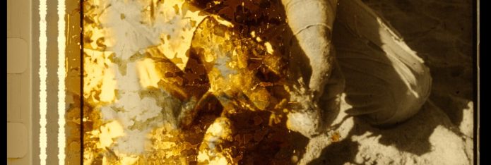 Frame from a nitrate film showing damage to the emulsion. The image is of someone's hands gutting a fish.